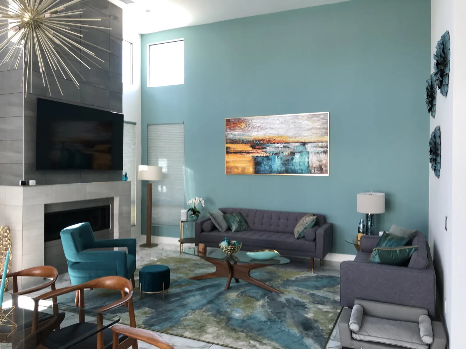 Living room with a teal accent wall and fireplace from the same home
