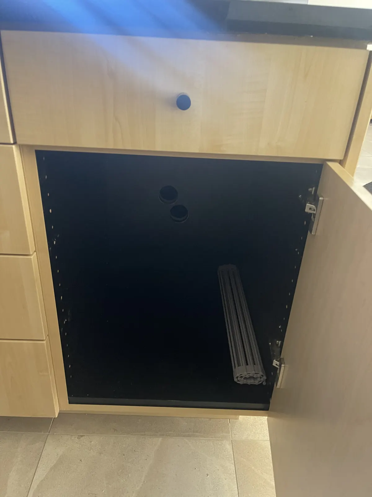 Light-oak cabinet with black interior and pull-out
