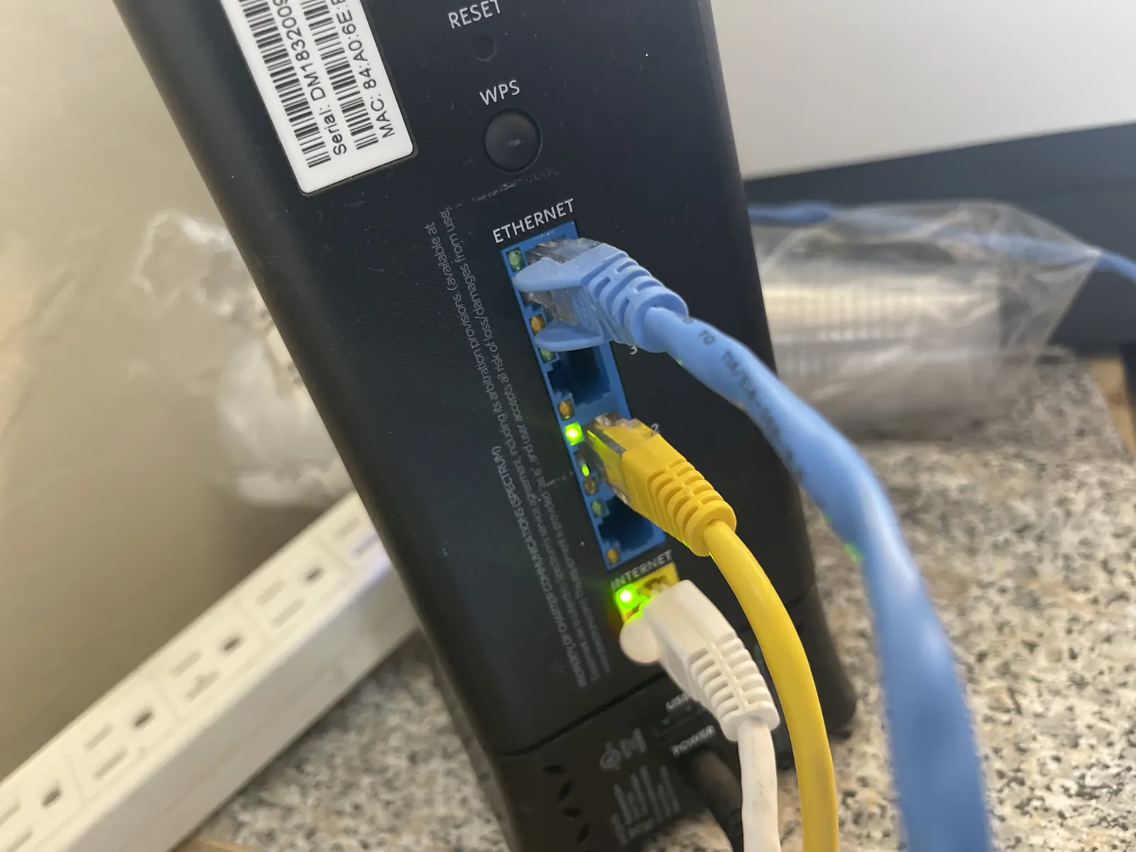 Modem/router with blue and yellow ethernet cables