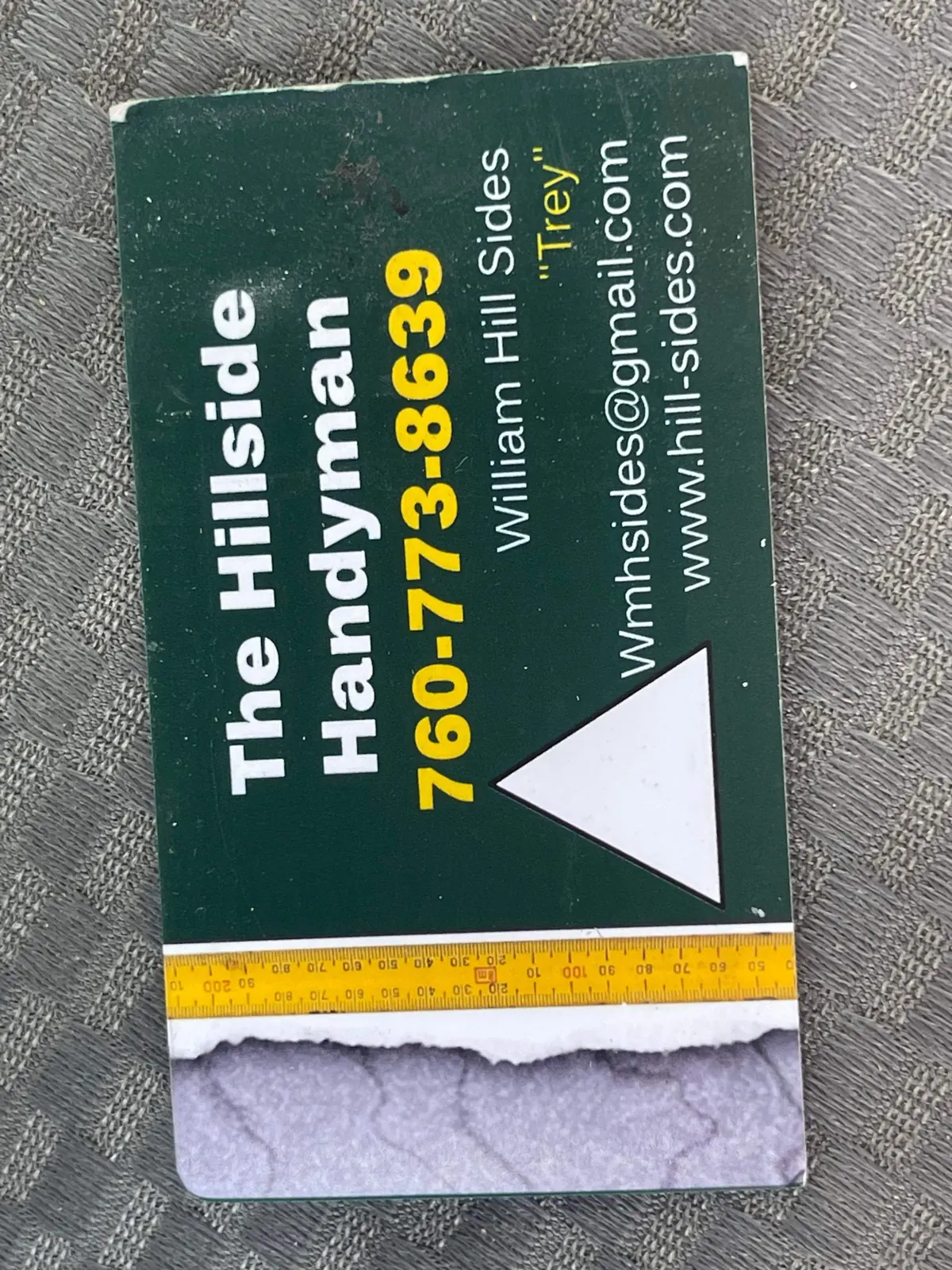 Worn green business card from The Hillside Handyman years in California