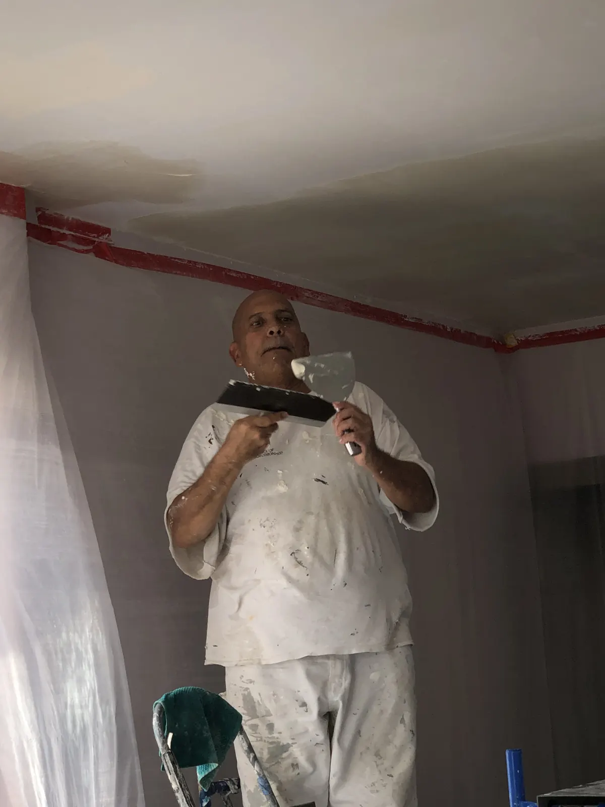 Painter at work on a ceiling