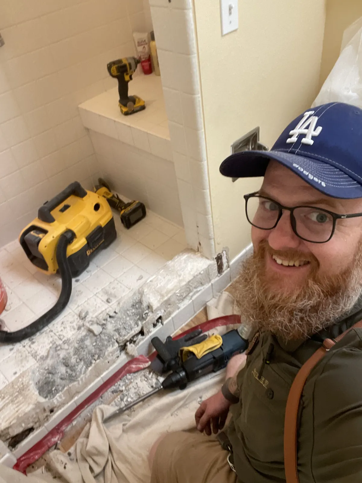 Owner on a job with a DeWalt drill and shop vac