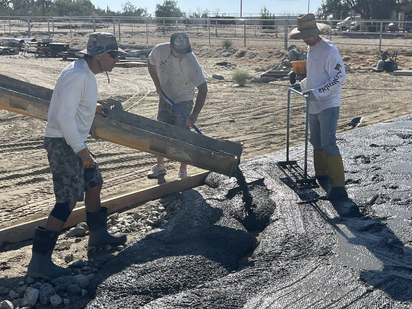 Concrete crew of three pouring a footing